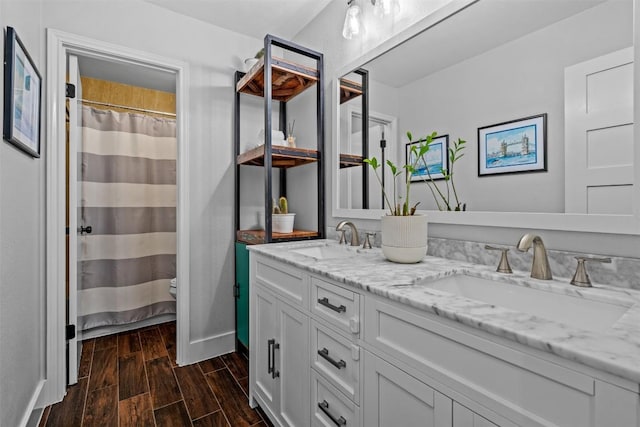 12420 Cassady Dr, Austin, TX 78727 - bathroom featuring double vanity, wood finished floors, and a shower with curtain