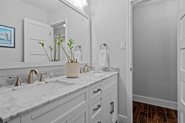 12420 Cassady Dr, Austin, TX 78727 - full bath with double vanity, wood finished floors, and baseboards