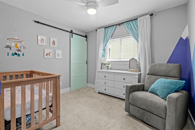12420 Cassady Dr, Austin, TX 78727 - bedroom featuring a barn door, light colored carpet, ceiling fan, and baseboards