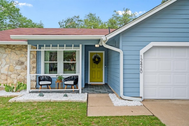 12420 Cassady Dr, Austin, TX 78727 - property entrance with an attached garage, a porch, and stone siding