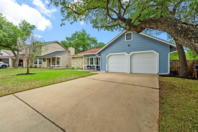 12420 Cassady Dr, Austin, TX 78727 - view of front of house with an attached garage and concrete driveway