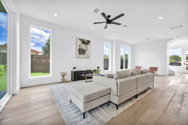 1302 Falcon Cv, Austin, TX 78745 - living room featuring healthy amount of natural light, light wood finished floors, recessed lighting, ceiling fan, and baseboards