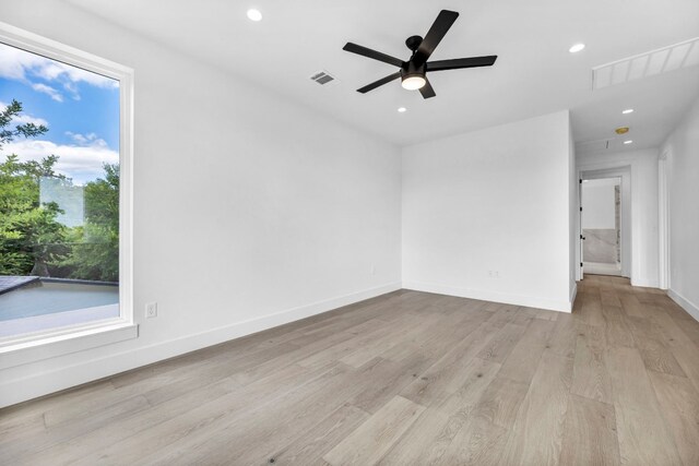 1302 Falcon Cv, Austin, TX 78745 - unfurnished room with light wood-style floors, ceiling fan, recessed lighting, and baseboards