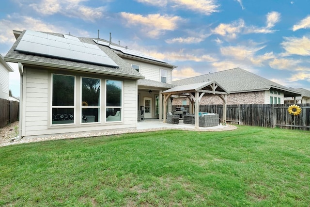 550 Cortona Ln, Georgetown, TX 78628 - back of property with outdoor lounge area, solar panels, a patio, and roof with shingles
