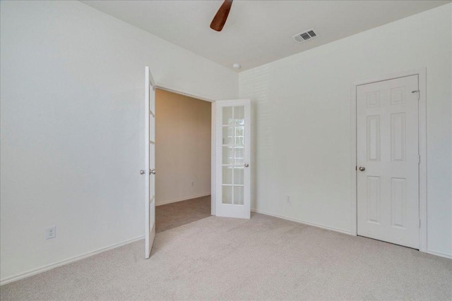 186 Sundown Ave, Buda, TX 78610 - unfurnished bedroom featuring french doors, carpet floors, ceiling fan, and baseboards