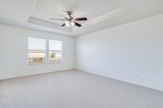 186 Sundown Ave, Buda, TX 78610 - unfurnished room featuring a raised ceiling, ornamental molding, ceiling fan, light colored carpet, and baseboards