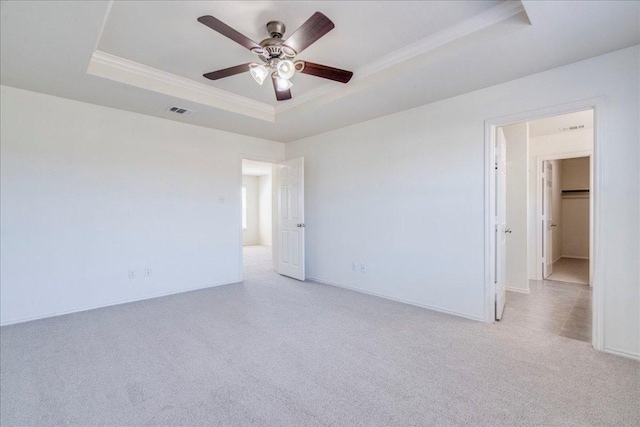 186 Sundown Ave, Buda, TX 78610 - unfurnished room featuring a tray ceiling, crown molding, light colored carpet, ceiling fan, and baseboards