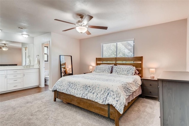 9214 Independence Loop, Austin, TX 78748 - bedroom featuring light colored carpet, ceiling fan, and connected bathroom