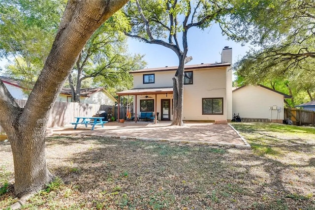 9214 Independence Loop, Austin, TX 78748 - back of property with a chimney, a patio, a fenced backyard, and ceiling fan