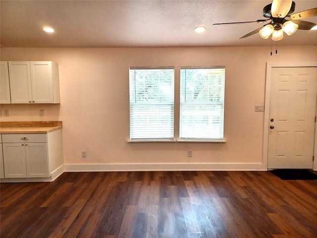 23393 Nameless Rd Unit 164, Leander, TX 78641 - unfurnished dining area featuring baseboards, ceiling fan, dark wood-type flooring, and recessed lighting