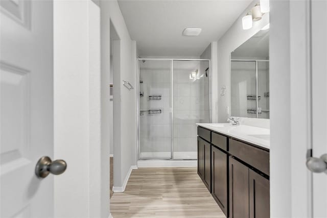 113 Bent Creek Ln, Georgetown, TX 78628 - full bathroom featuring a shower stall, double vanity, and wood finished floors