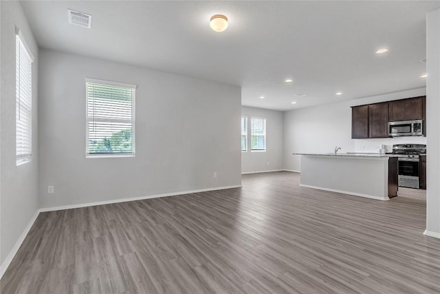113 Bent Creek Ln, Georgetown, TX 78628 - unfurnished living room featuring light wood-style flooring and recessed lighting