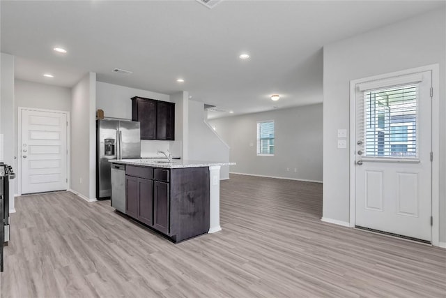 113 Bent Creek Ln, Georgetown, TX 78628 - kitchen with plenty of natural light, dark brown cabinetry, light wood-style flooring, and recessed lighting