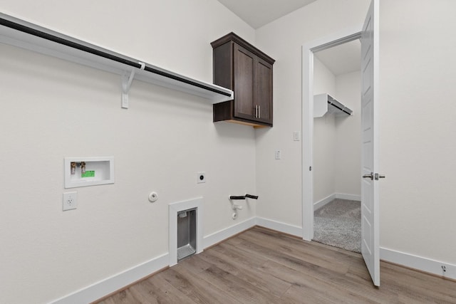 601 Gunison Dr, Lakeway, TX 78738 - laundry area with gas dryer hookup, hookup for a washing machine, hookup for an electric dryer, light wood-type flooring, and cabinet space