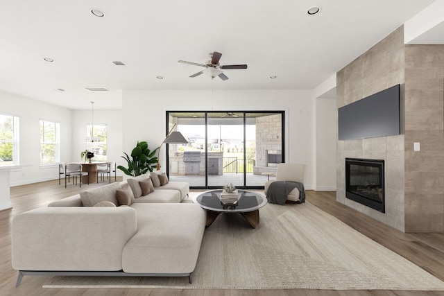 601 Gunison Dr, Lakeway, TX 78738 - living area with wood finished floors, baseboards, a fireplace, ceiling fan, and recessed lighting