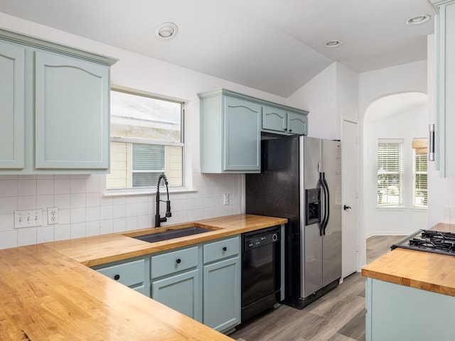 8425 Shallot Way, Austin, TX 78748 - kitchen with wooden counters, a sink, dishwasher, light wood finished floors, and stainless steel fridge with ice dispenser