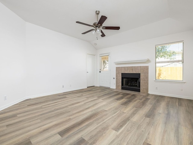 8425 Shallot Way, Austin, TX 78748 - unfurnished living room featuring wood finished floors, a ceiling fan, baseboards, a fireplace, and lofted ceiling
