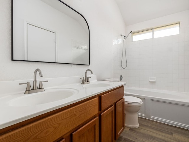 8425 Shallot Way, Austin, TX 78748 - bathroom featuring toilet, double vanity, shower / bathtub combination, and wood finished floors