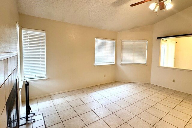 1121 Peggotty Pl, Austin, TX 78753 - unfurnished room featuring a textured ceiling, a ceiling fan, lofted ceiling, and light tile patterned floors