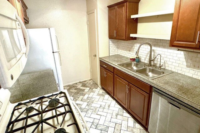 1121 Peggotty Pl, Austin, TX 78753 - kitchen featuring dishwasher, decorative backsplash, freestanding refrigerator, and brick patterned floors