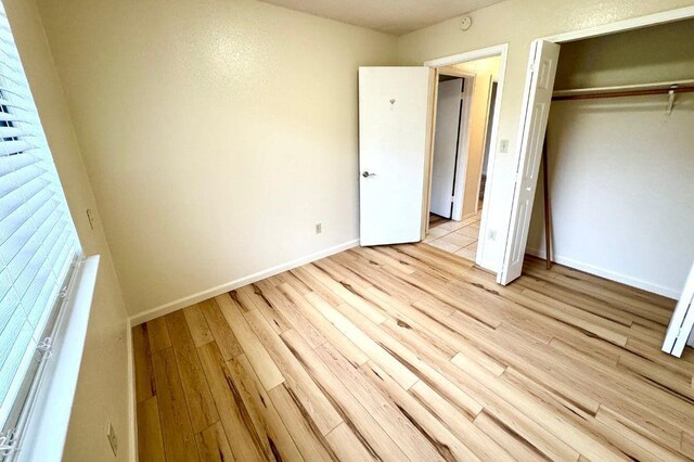 1121 Peggotty Pl, Austin, TX 78753 - unfurnished bedroom featuring light wood-type flooring and a closet