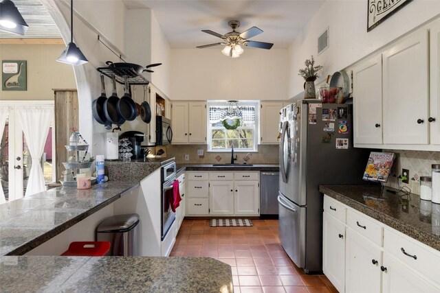 4414 Three Creek Trl, Spicewood, TX 78669 - kitchen with appliances with stainless steel finishes, a ceiling fan, a sink, white cabinetry, and tasteful backsplash