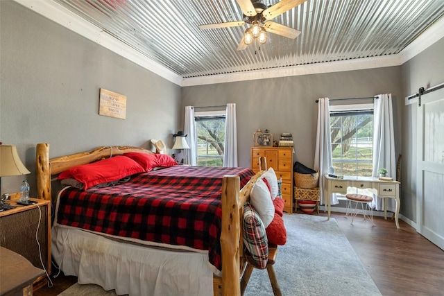 4414 Three Creek Trl, Spicewood, TX 78669 - bedroom featuring wood finished floors, crown molding, a barn door, wood ceiling, and a ceiling fan