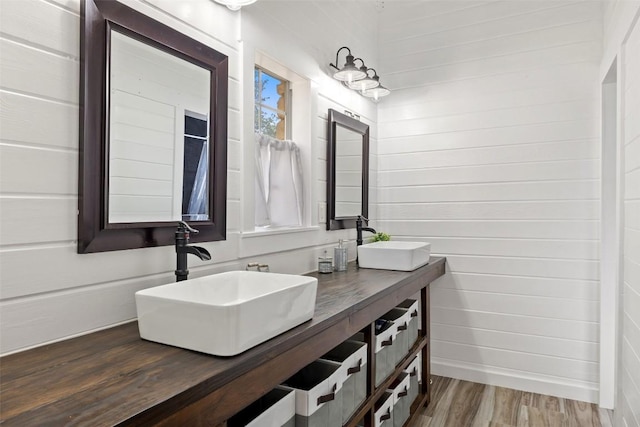 4414 Three Creek Trl, Spicewood, TX 78669 - bathroom with double vanity, wood finished floors, and wood walls