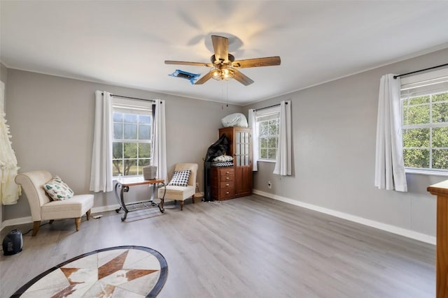 4414 Three Creek Trl, Spicewood, TX 78669 - living area with plenty of natural light, wood finished floors, and baseboards