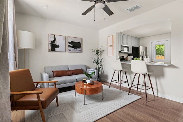 1618 Webberville Rd Unit B, Austin, TX 78721 - living area featuring wood finished floors and a ceiling fan