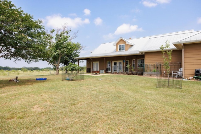 192 Indian Oaks Pass, Blanco, TX 78606 - rear view of property with french doors, a lawn, and a metal roof