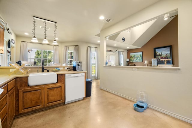 192 Indian Oaks Pass, Blanco, TX 78606 - kitchen with white dishwasher, brown cabinetry, finished concrete flooring, recessed lighting, and light countertops
