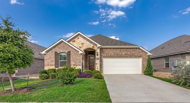 2212 Mcclendon Trl, Leander, TX 78641 - view of front of property with brick siding, a garage, concrete driveway, a front yard, and stone siding