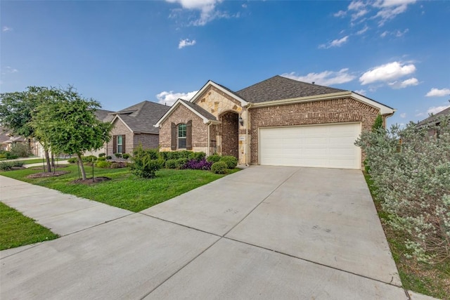 2212 Mcclendon Trl, Leander, TX 78641 - view of front of property with brick siding, an attached garage, a front lawn, concrete driveway, and roof with shingles