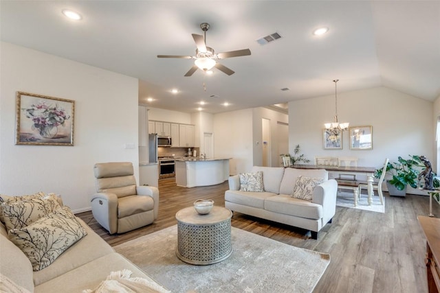 2212 Mcclendon Trl, Leander, TX 78641 - living area with light wood finished floors, ceiling fan, a chandelier, recessed lighting, and baseboards