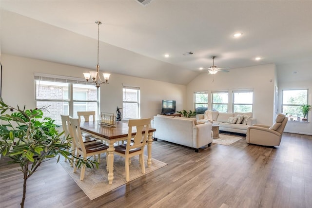 2212 Mcclendon Trl, Leander, TX 78641 - dining space featuring plenty of natural light, wood finished floors, a chandelier, vaulted ceiling, and recessed lighting