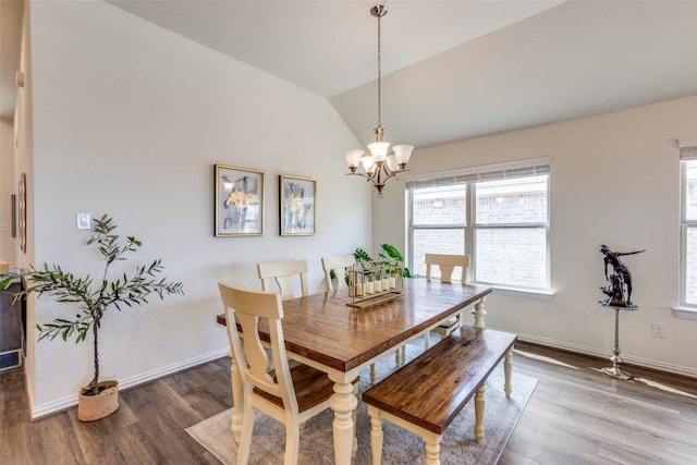 2212 Mcclendon Trl, Leander, TX 78641 - dining room featuring plenty of natural light, wood finished floors, a chandelier, vaulted ceiling, and baseboards