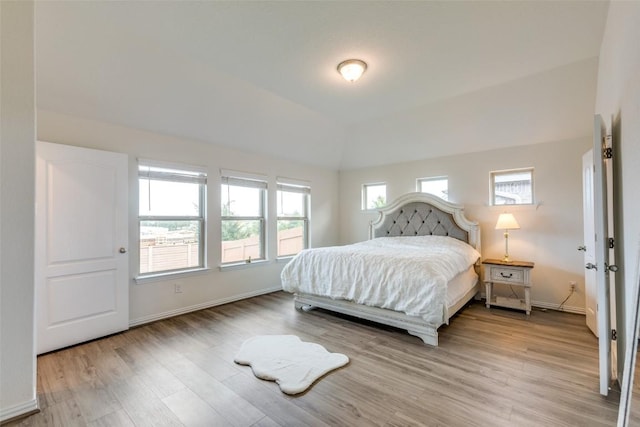 2212 Mcclendon Trl, Leander, TX 78641 - bedroom featuring wood finished floors, baseboards, and vaulted ceiling