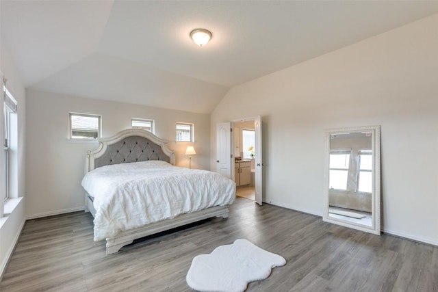 2212 Mcclendon Trl, Leander, TX 78641 - bedroom with wood finished floors, lofted ceiling, and baseboards