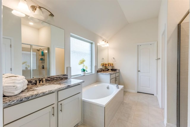 2212 Mcclendon Trl, Leander, TX 78641 - bathroom featuring vaulted ceiling, a shower stall, vanity, and a bath