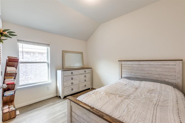 2212 Mcclendon Trl, Leander, TX 78641 - bedroom featuring light wood-style floors, vaulted ceiling, and baseboards