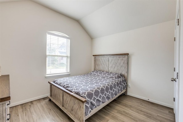 2212 Mcclendon Trl, Leander, TX 78641 - bedroom featuring lofted ceiling, light wood-style floors, and baseboards