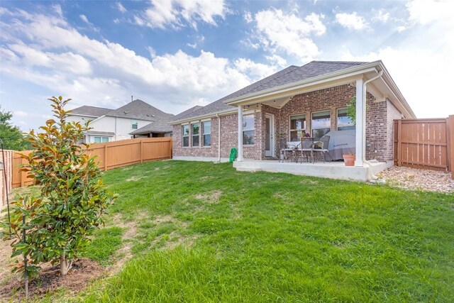 2212 Mcclendon Trl, Leander, TX 78641 - rear view of house with brick siding and a patio