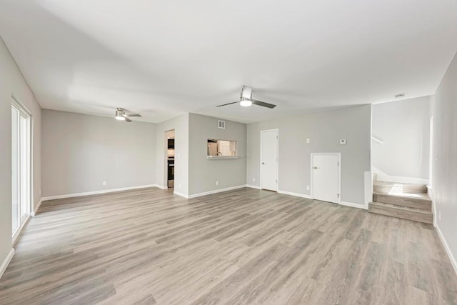 6718 Silvermine Dr Unit 804, Austin, TX 78736 - unfurnished living room with ceiling fan, baseboards, stairs, and light wood-style floors