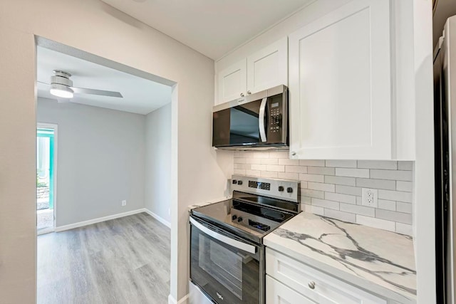 6718 Silvermine Dr Unit 804, Austin, TX 78736 - kitchen featuring stainless steel appliances, decorative backsplash, light wood-type flooring, light stone countertops, and white cabinetry