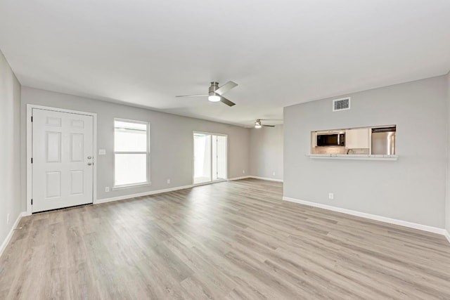 6718 Silvermine Dr Unit 804, Austin, TX 78736 - unfurnished living room featuring ceiling fan, light wood-type flooring, and baseboards