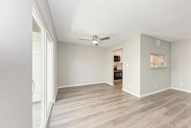 6718 Silvermine Dr Unit 804, Austin, TX 78736 - spare room featuring light wood-style flooring, a ceiling fan, and baseboards