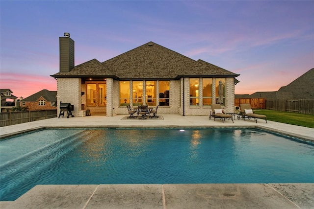 116 Egret Ln, Austin, TX 78737 - back of house featuring a chimney, a patio, a fenced backyard, and brick siding