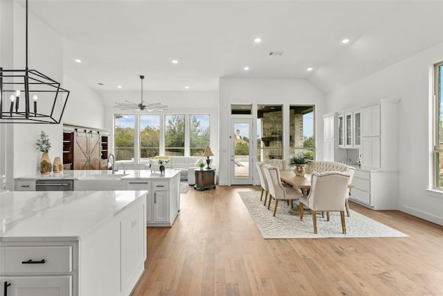 116 Egret Ln, Austin, TX 78737 - kitchen featuring healthy amount of natural light, white cabinetry, dishwasher, light wood finished floors, and recessed lighting