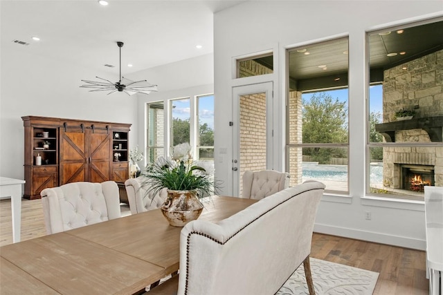 116 Egret Ln, Austin, TX 78737 - dining area with wood finished floors, recessed lighting, a stone fireplace, and ceiling fan